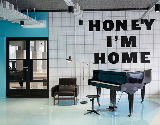 Piano in front of "Honey, I'm Home" sign at The Student Hotel The Hague